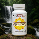 AyuMantra Ayustone dietary supplement bottle on a rock with a waterfall background