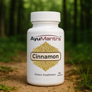 AyuMantra Cinnamon dietary supplement bottle with a forest background