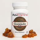 AyuMantra Guggulu dietary supplement bottle with guggulu tablets on a white background