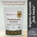 Package of AyuMantra Shankhapushpi Powder with branding and product details on a light gray background