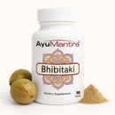 AyuMantra Bhibitaki dietary supplement bottle with fruits and powder on a white background.