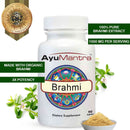 AyuMantra Brahmi dietary supplement bottle with Brahmi leaves and powder on a white background.