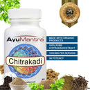 AyuMantra Chitrakadi supplement bottle with ingredients and certification badge on a white background.