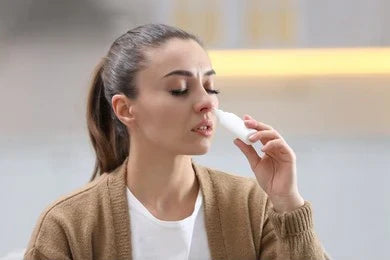 Woman inhaling steam due to nasal blockage