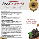 Product information card for AyuMantra Pure Ayurveda capsules, showing the brand logo, product facts in English and French, usage directions, and a gold seal indicating organic peepali herb extract. A small photo of whole black pepper appears in the bottom right corner.