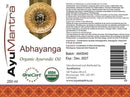Label of AyuMantra Abhayanga Organic Ayurvedic Oil with certification logos and product details.