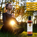 Woman meditating outdoors benefits with a bottle of Ayurvedic oil in the foreground