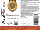 Label of AyuMantra Dhanwantharam Organic Ayurvedic Oil with branding and certification logos.