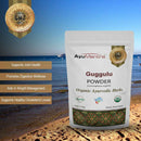 AyuMantra Guggulu Powder benefits packaged with the beach background
