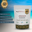 AyuMantra Jatamansi Powder packaging with product details and benefits on a scenic background