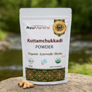 AyuMantra Kottamchukkadi Powder packaging with herbs on a natural background
