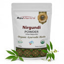 AyuMantra Nirgundi Powder packaging with green leaves and flowers on a white background