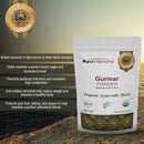 AyuMantra Gurmar Powder packaging with product details on a textured surface.
