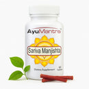 AyuMantra Sariva Manjishta dietary supplement bottle with a leaf and stick on a white background
