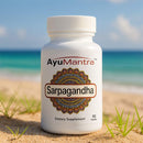 AyuMantra Sarpagandha dietary supplement bottle on a beach