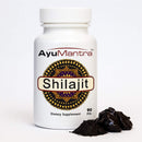 AyuMantra Shilajit pills bottle with Shilajit resin chunks and powder, Ayurvedic mineral supplement product
