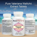 Three white supplement bottles labeled AyuMantra Tagar Pure Valeriana Wallichii Extract Tablets are shown against a beach backdrop with ocean waves and sky. The center bottle is front-facing, while the left and right bottles show side and back panels with text details.