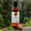Bottle of AyuVedha Tridoshic Organic Ayurvedic Oil on a rock with a natural background