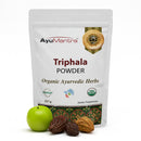 AyuMantra Triphala Powder packaging with organic certification logos on a white background