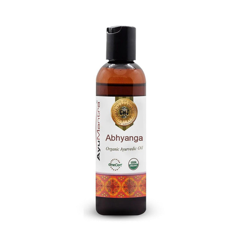 Bottle of Abhyanga organic ayurvedic oil with a white label on a white background