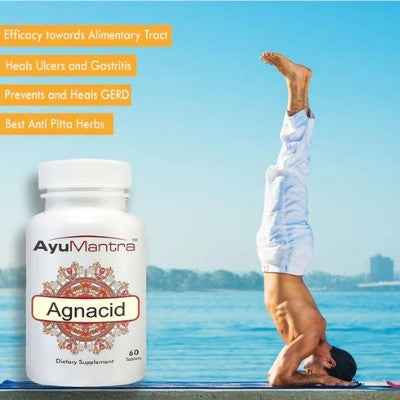 AyuMantra Agnacid supplement bottle with a person doing a handstand by a lake.