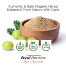 AyuMantra Amalaki Powder in wooden bowl with amla fruits and gluten free organic vegan icons