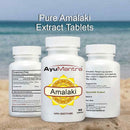 AyuMantra Amalaki extract tablets with a beach background.
