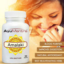 AyuMantra Amalaki supplement bottle with a woman smiling in the background.