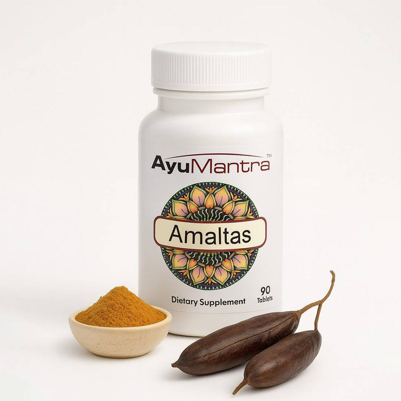 AyuMantra Amaltas dietary supplement bottle with a small bowl of powder and two dried fruits on a white background.