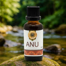 Bottle of ANU oil on a mossy rock with a natural background