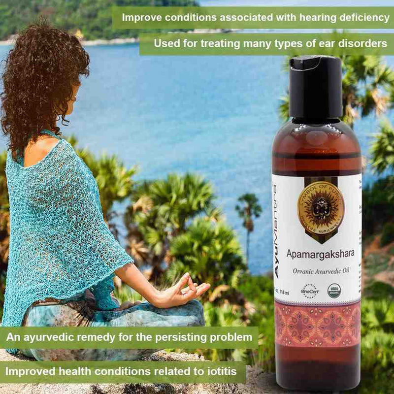 Woman meditating by a scenic lake with an Ayurvedic oil bottle labeled 'Apamargakshara' in the foreground.