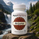 AyuMantra Arjuna dietary supplement bottle with a mountainous background.