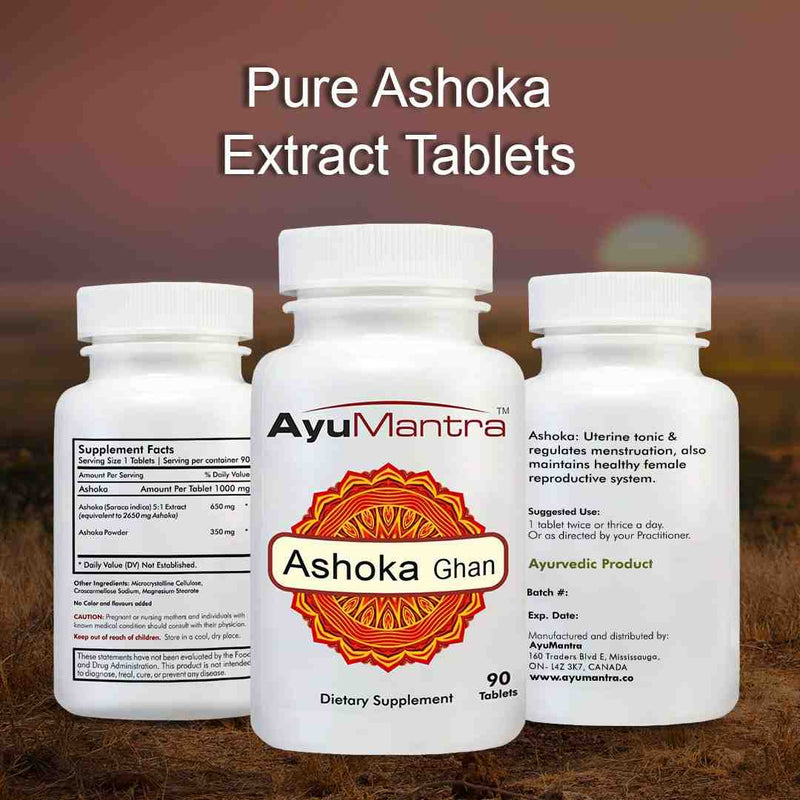 Three bottles of AyuMantra Ashoka Ghan dietary supplements on a blurred natural background.