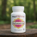 AyuMantra Ashwashila dietary supplement bottle on a wooden surface with a natural background.
