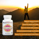 AyuMantra Ashwashila supplement bottle with person celebrating on a mountain at sunset.