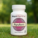 AyuMantra Ayufem dietary supplement bottle on grass with a blurred green background.