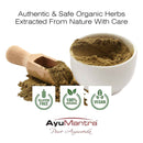 Herbal powder in a white bowl with a wooden scoop, labeled as authentic and safe organic herbs from AyuMantra.