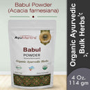 Package of AyuMantra Babul Powder with branding and product details on a light gray background