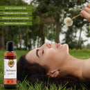 Woman lying on grass with Bal-Shatavari Ayurvedic Oil bottle, surrounded by nature.