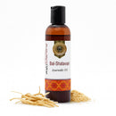 Bottle of Bal-Shatavari Ayurvedic Oil with roots and seeds on a white background