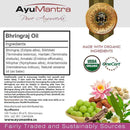 AyuMantra Bhringraj Oil packaging with ingredients list, organic certification logos, and natural elements.