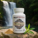 AyuMantra Bhringraj dietary supplement bottle with a natural background featuring a waterfall.