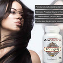 Woman with long hair next to a bottle of AyuMantra Bhringraj supplement on a white background.
