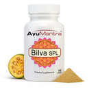 AyuMantra Bilva SPL dietary supplement bottle with bilva fruit and powder on a white background.