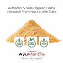 Pile of organic herbs with AyuMantra branding and certification logos on a white background