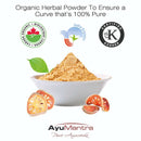 Bowl of organic herbal powder with AyuMantra branding and certification logos on a white background