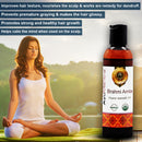 Brahmi Amla organic ayurvedic oil bottle with a woman meditating in the background