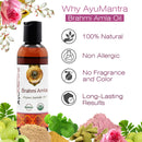 AyuMantra Brahmi Amla oil bottle with product features and natural ingredients on a white background