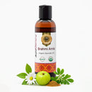 Brahmi Amla organic ayurvedic oil bottle with ingredients on a white background