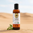 Brahmi organic ayurvedic oil bottle on sand with desert background